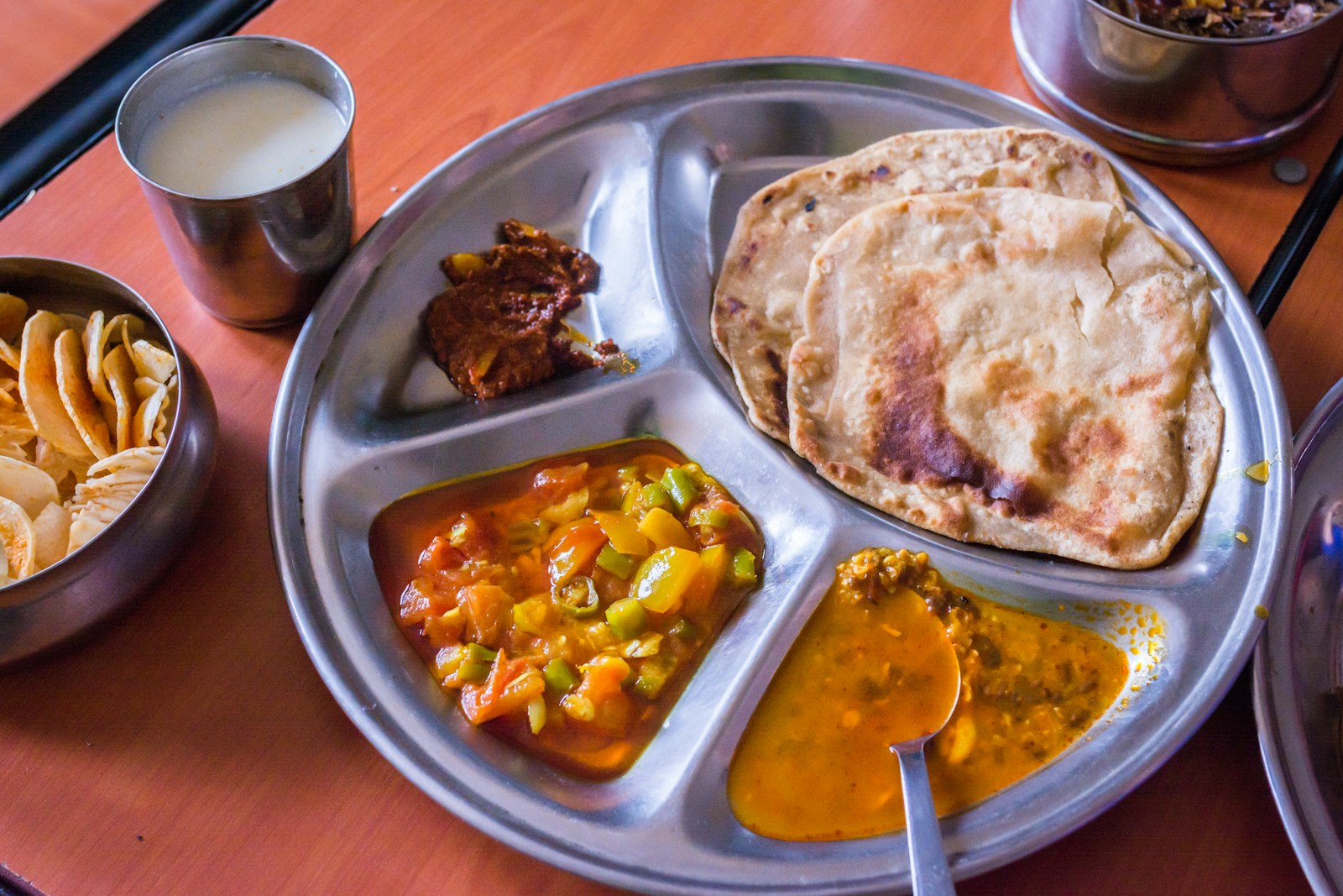 Traditional Indian dishes, breads and rice served together